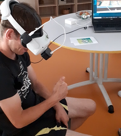 A young adult with autism is trying out a virtual reality experience to improve their independence
